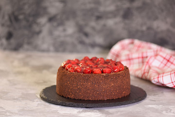 Delicious homemade chocolate cheesecake decorated with cherry sauce.