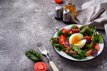 Healthy salad with prosciutto, tomato and egg