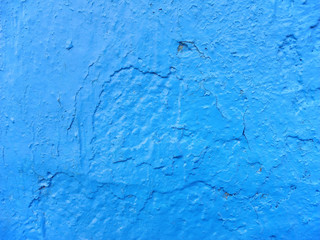 Rough concrete wall surface painted bright blue