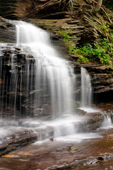 Waterfall over ledge rock with water blur