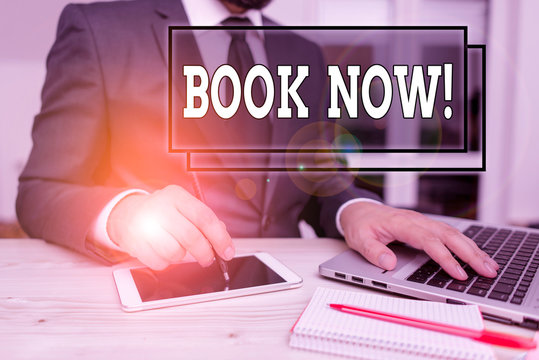 Text sign showing Book Now. Business photo text guaranteed to have place because you have already purchased it Male human wear formal clothes present presentation use hi tech smartphone