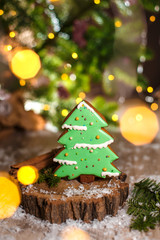 Holiday traditional food bakery. Gingerbread green christmas tree in cozy warm decoration with garland lights