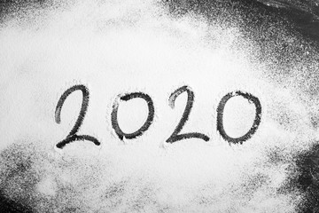 2020 figures with handwriting on white powder
