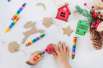 Close up of kids hands drawing handmade corrugated cardboard decorations