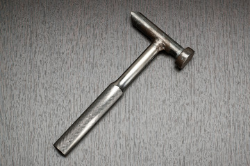 Little hammer lies on the table, close up