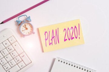 Text sign showing Plan 2020. Business photo text detailed proposal doing achieving something next year White pc keyboard with empty note paper and pencil above white background