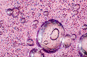 Macro of transparent slime with glittering particles and air bubbles