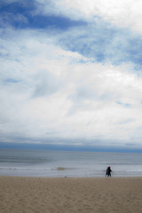 Fototapeta na wymiar Beach walk with interesting clouds
