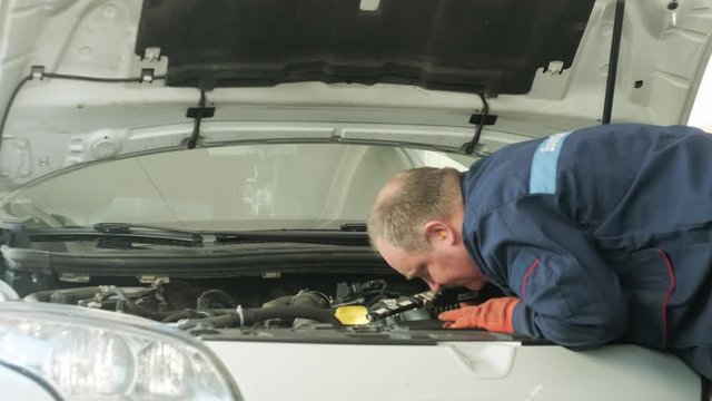 Mechanic working on a car engine
