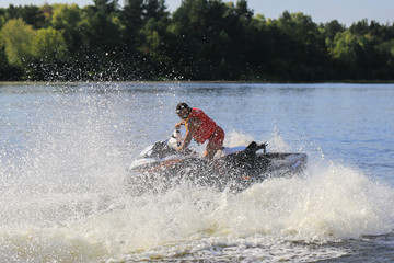 Fototapeta na wymiar Man riding jet ski on the water