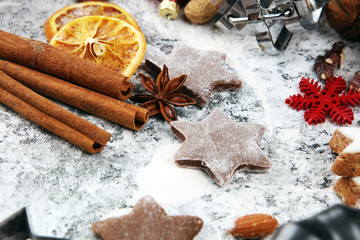 Baking christmas cookies. Typical cinnamon stars bakery with spices. xmas decoration on table