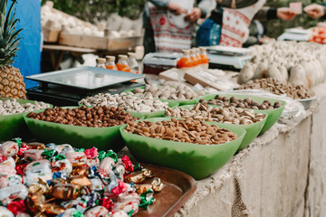 Different nuts in shop, market. Desk in store with various hazelnuts, peanuts, walnuts and other...