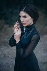 silhouette of a gothic lady from an old fantasy horror movie. Beautiful vampire hunter. Black...