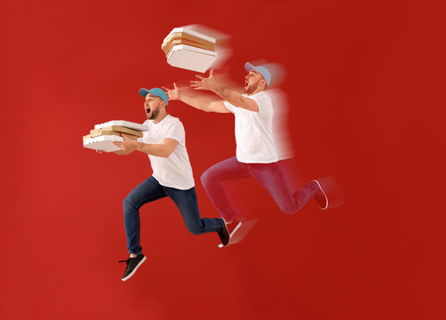 Jumping male courier with pizza boxes on color background