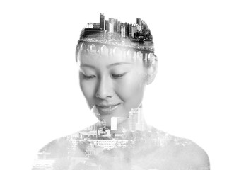 Triple exposure of young Asian woman and modern city