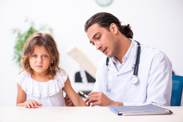 Young doctor pediatrician with small girl