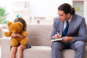 Child psychologist attending small girl