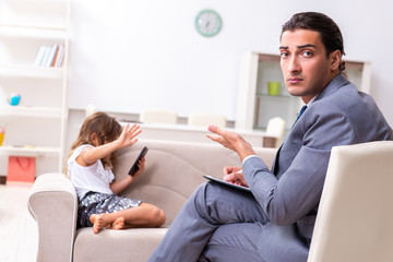 Child psychologist attending small girl