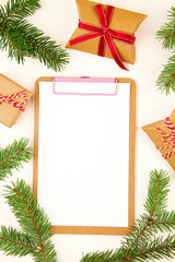 Top view over Christmas composition with gifts, xmas tree, note pad