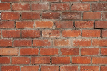 Fototapeta premium Old red brick wall in Italy. Faded red color, a bit dirty. Copy space for text