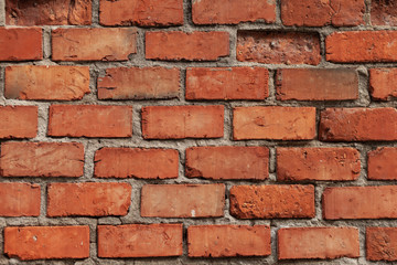 Fototapeta premium Old red brick wall in Italy. Faded red color, a bit dirty. Copy space for text
