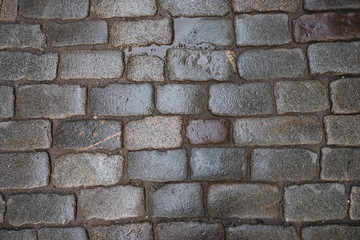 Fototapeta premium wet cobblestone that have been worn down by time