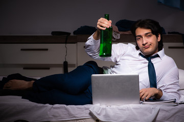 Young employee working at home after night shift