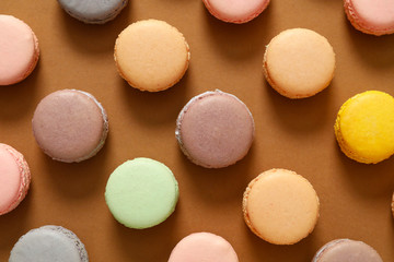 Tasty macarons on color background