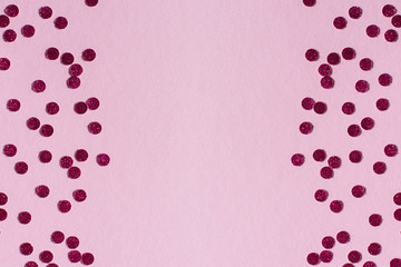 Bright round confetti on a pink background, festive background