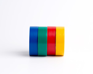 full coils of multi-colored insulating tape on a white background