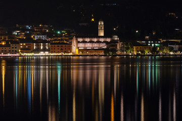 Fototapeta na wymiar Evening panoramic view of the center of Salo Lake Garda. City night lights reflected in water