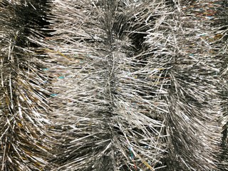 Beautiful tinsel, great design for any purposes. New year card. Bright tinsel, Christmas background, shiny pattern. Colorful decoration.