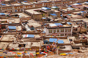 Upper view of traditional Tibetan houses in Gyantse, with blue and brown roofs.
