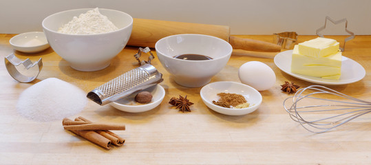 Baking gingerbread cookies for Christmas, ingredients and utilities on a wooden light worktop in...