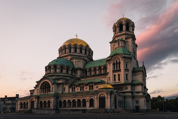 Famous Cathedral Saint Aleksandar Nevski during sunrise with illuminated colourful clouds during summer morning (Sofia, Bulgaria, Europe)