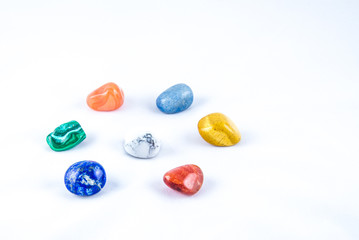 Colored chakra stones in a circle,each one representing one chakra color