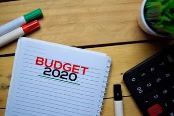 Budget 2020 write on the book with wooden table background