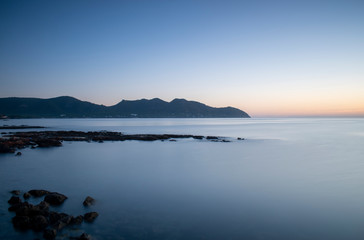 Sunrise near Cala Bona Mallorca with a silky flat sea giving a serene and enigmatic feel to the early morning.