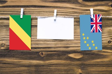 Hanging flags of Republic Of The Congo and Tuvalu attached to rope with clothes pins with copy...