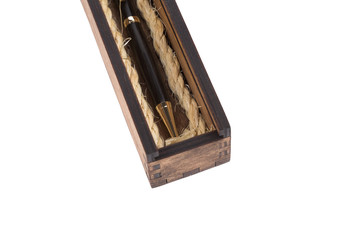 Beautiful wooden box with ballpoint pen inside on a white background.