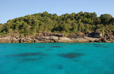 Fototapeta na wymiar Underwater rocks showing through the turquoise sea of the Similan Islands in Thailand