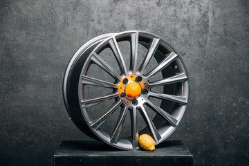 Car rims at the dark background with orange and lemon close up