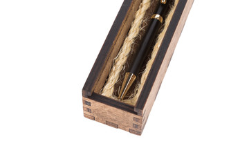 Beautiful wooden box with ballpoint pen inside on a white background.