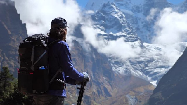 Active hiker hiking next toThamserku mountain in Nepal. Static handled shot, Travel sport lifestyle concept