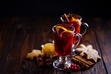 Two glasses of mulled wine with orange slices at Christmas time. Winter holidays celebration, warming mood, cozy home concept