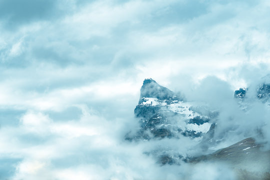 Misty Clouds Filling The Sky And Covering Rugged Moutains