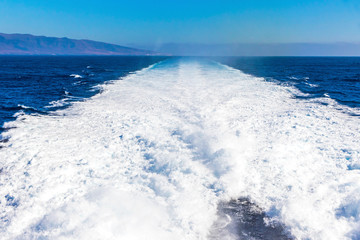 Water trail foaming behind a ferry boat in Atlantic ocean between Canary islands, Spain....