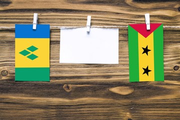 Hanging flags of Saint Vincent And The Grenadines and Sao Tome And Principe attached to rope with...