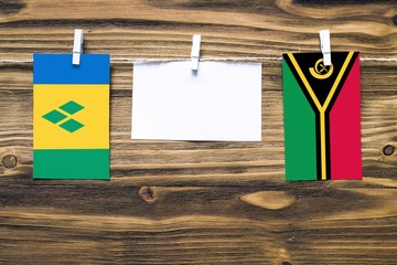 Hanging flags of Saint Vincent And The Grenadines and Vanuatu attached to rope with clothes pins...