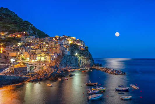 Long exposure view of Manarola with lights in the evening